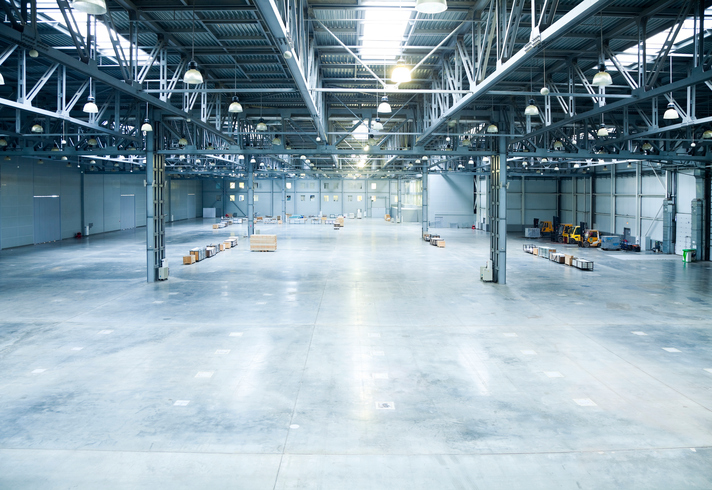 The inside of a large and empty modern warehouse